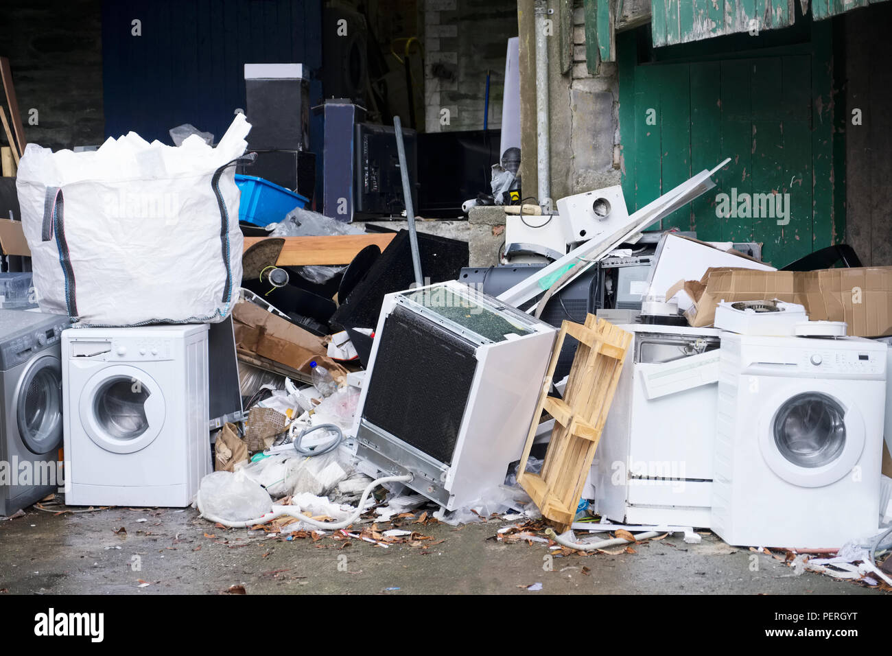 washing-machines-for-recycling-storage-dumped-with-waste-and-rubbish-to-help-reduce-pollution-PERGYT